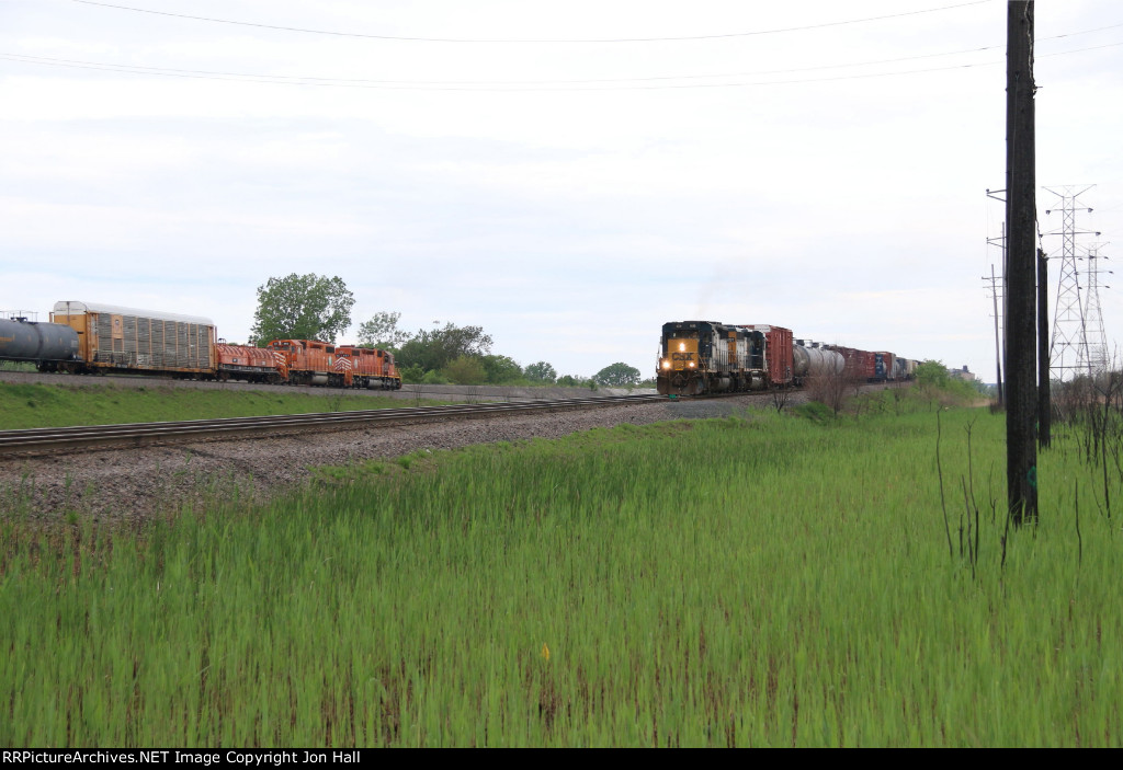 The Kirk Yard west end puller and the CSX transfer slowly roll east side by side